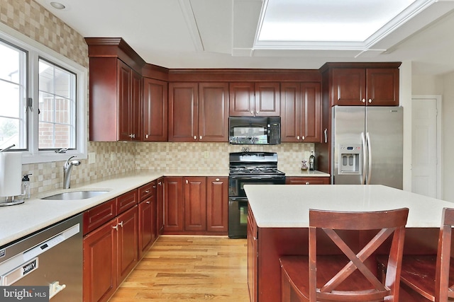 4501 Highland Green Ct, Alexandria, VA 22312 - kitchen featuring black appliances, a sink, light countertops, and light wood-style flooring