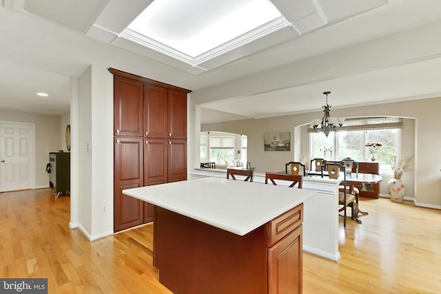 4501 Highland Green Ct, Alexandria, VA 22312 - kitchen featuring light wood-style floors, light countertops, a center island, hanging light fixtures, and recessed lighting