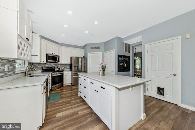 3001 Swiper Dr, Manchester, MD 21102 - kitchen with appliances with stainless steel finishes, a sink, wood finished floors, tasteful backsplash, and recessed lighting