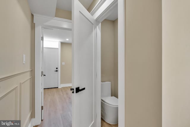 bathroom with wood finished floors and toilet