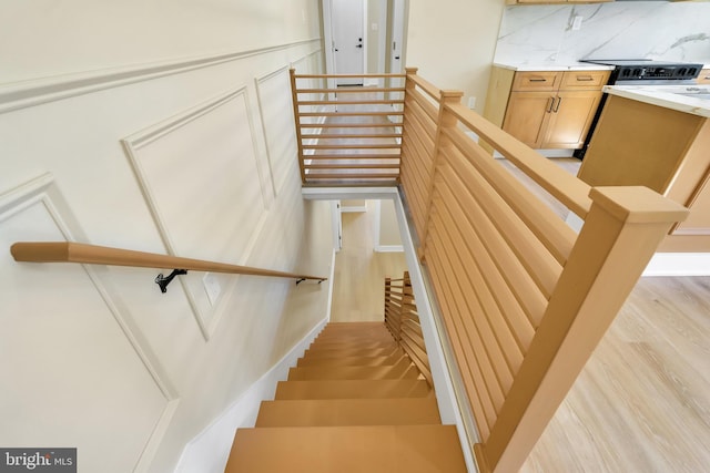 stairs featuring wood finished floors