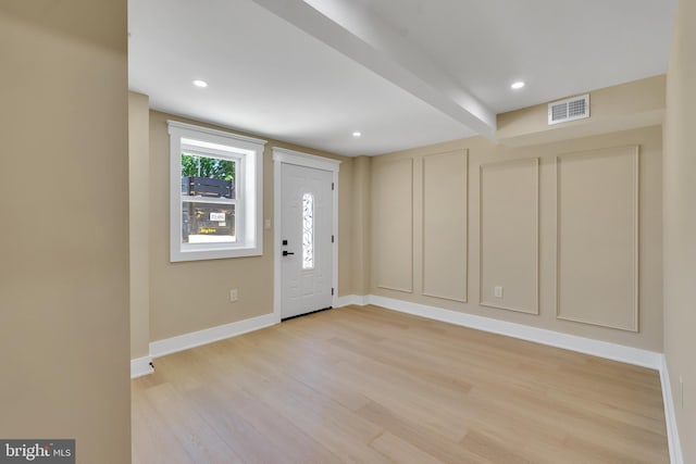 entrance foyer featuring light wood-type flooring, baseboards, beam ceiling, and recessed lighting