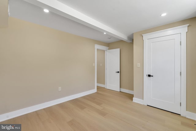 unfurnished bedroom with light wood-type flooring, baseboards, and recessed lighting