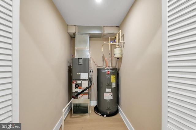 utility room with electric water heater and heating unit