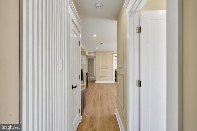 hall with light wood-style flooring and recessed lighting