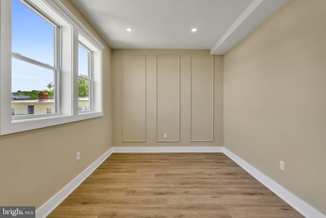 empty room with recessed lighting, baseboards, and light wood finished floors
