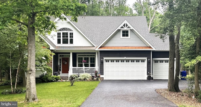 20 Parker Dr, Millsboro, DE 19966 - view of front facade featuring roof with shingles, driveway, an attached garage, a front lawn, and covered porch