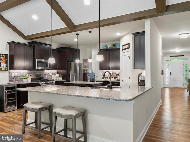 20 Parker Dr, Millsboro, DE 19966 - kitchen with appliances with stainless steel finishes, a sink, beverage cooler, wood finished floors, and beamed ceiling