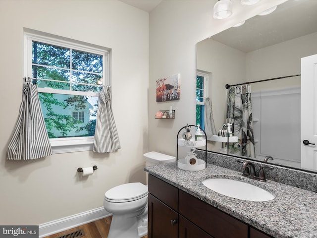 20 Parker Dr, Millsboro, DE 19966 - full bathroom featuring wood finished floors, vanity, baseboards, toilet, and a shower with shower curtain