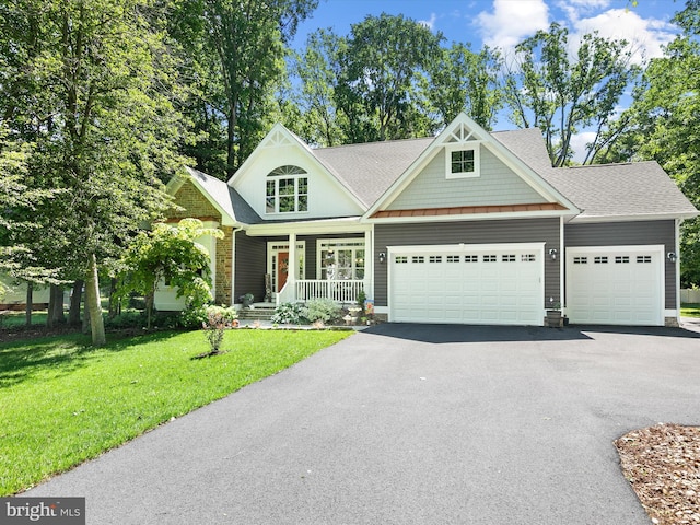 20 Parker Dr, Millsboro, DE 19966 - view of front of house featuring a garage, driveway, covered porch, a front lawn, and a shingled roof