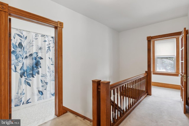 3113 White Ave, Baltimore, MD 21214 - hallway with an upstairs landing, light carpet, and baseboards
