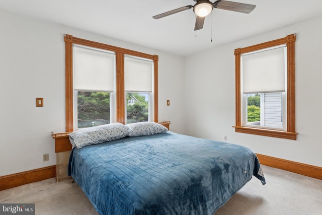 3113 White Ave, Baltimore, MD 21214 - carpeted bedroom featuring multiple windows, baseboards, and ceiling fan