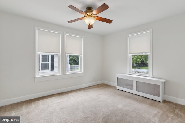 3113 White Ave, Baltimore, MD 21214 - carpeted spare room featuring baseboards, ceiling fan, and radiator heating unit