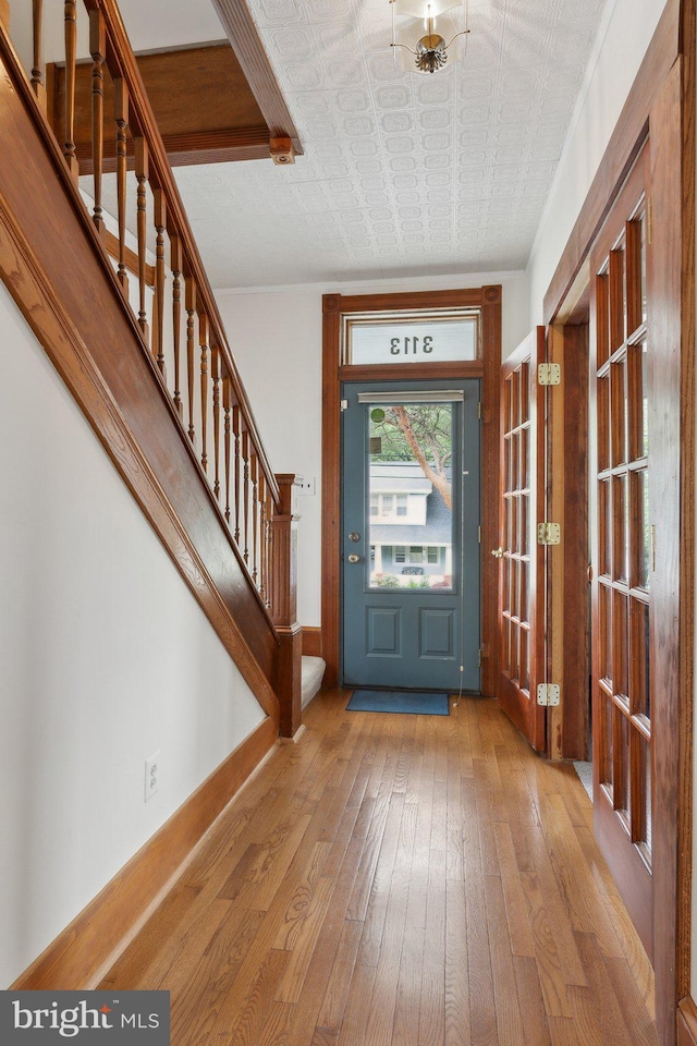 3113 White Ave, Baltimore, MD 21214 - foyer with hardwood / wood-style floors, stairs, baseboards, french doors, and an ornate ceiling