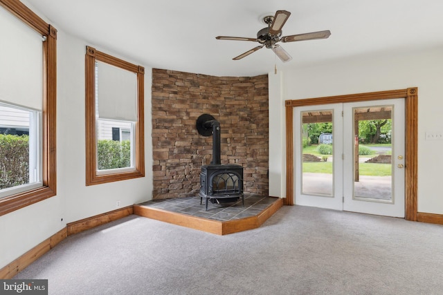 3113 White Ave, Baltimore, MD 21214 - unfurnished living room with a wood stove, plenty of natural light, carpet, and baseboards