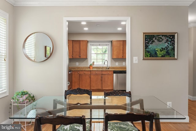 23 Linden Ave, Annapolis, MD 21401 - kitchen with stainless steel dishwasher, brown cabinetry, light wood-type flooring, a sink, and recessed lighting