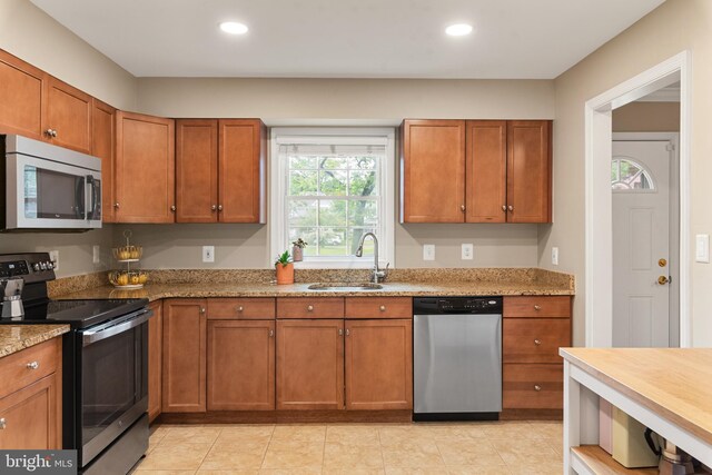 23 Linden Ave, Annapolis, MD 21401 - kitchen with stainless steel appliances, a sink, brown cabinetry, recessed lighting, and light stone countertops