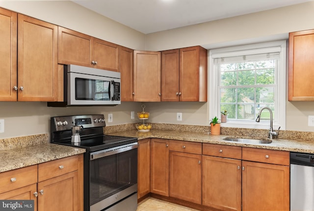 23 Linden Ave, Annapolis, MD 21401 - kitchen with appliances with stainless steel finishes, a sink, brown cabinets, and light stone countertops