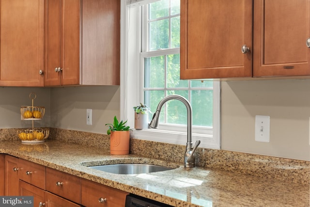 23 Linden Ave, Annapolis, MD 21401 - kitchen with brown cabinets, a sink, light stone countertops, and dishwashing machine