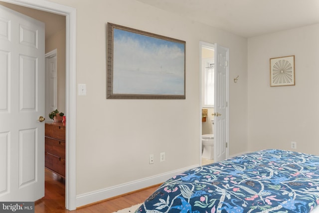 23 Linden Ave, Annapolis, MD 21401 - bedroom with wood finished floors, baseboards, and ensuite bathroom