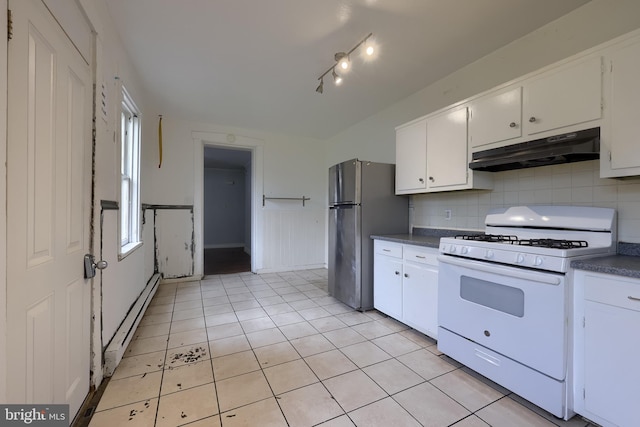 kitchen featuring white gas range, under cabinet range hood, freestanding refrigerator, dark countertops, and a baseboard radiator