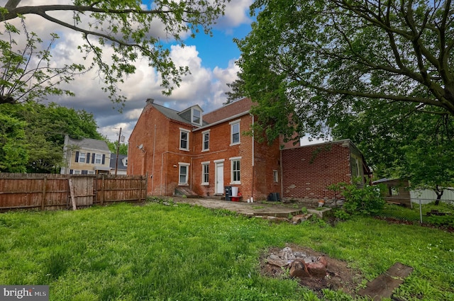 back of property featuring brick siding and a patio area