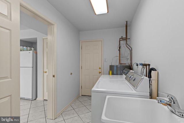 407 Stanford Rd, Fairless Hills, PA 19030 - laundry room featuring separate washer and dryer, electric water heater, and light tile patterned floors