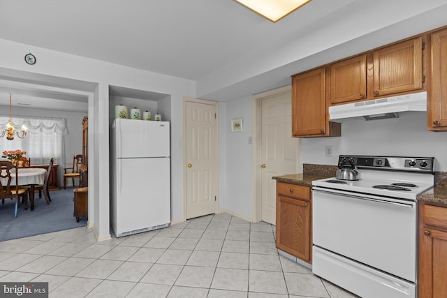 407 Stanford Rd, Fairless Hills, PA 19030 - kitchen with white appliances, under cabinet range hood, brown cabinetry, and a chandelier