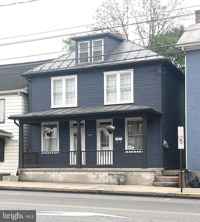 402 E King St, Shippensburg, PA 17257 - view of front of home featuring a standing seam roof, a porch, and metal roof