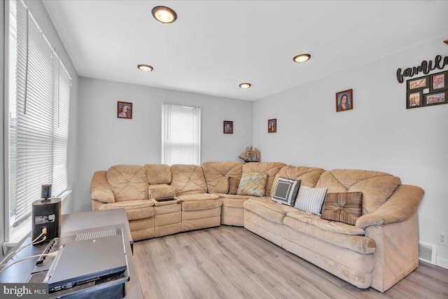 living room with wood finished floors and recessed lighting