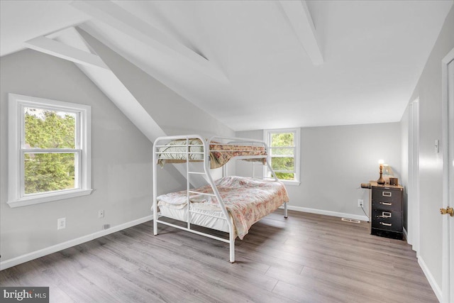 bedroom featuring wood finished floors and baseboards