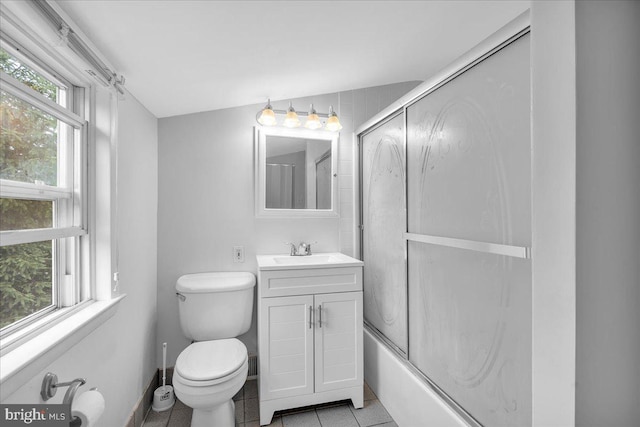 full bathroom featuring tile patterned flooring, toilet, bath / shower combo with glass door, and vanity