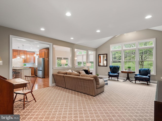 living room with recessed lighting, baseboards, vaulted ceiling, light wood-style flooring, and light carpet