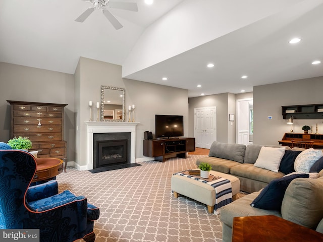 living area featuring a ceiling fan, recessed lighting, a fireplace with flush hearth, light carpet, and high vaulted ceiling