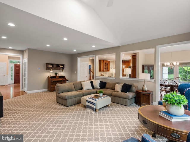 living room with recessed lighting, a chandelier, vaulted ceiling, baseboards, and light colored carpet