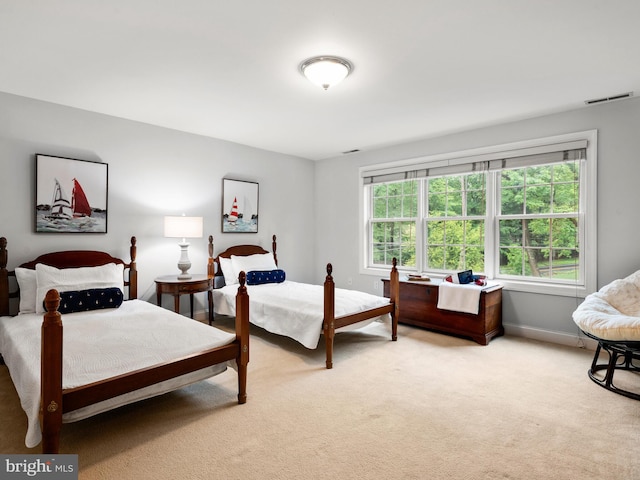 bedroom featuring light colored carpet and baseboards