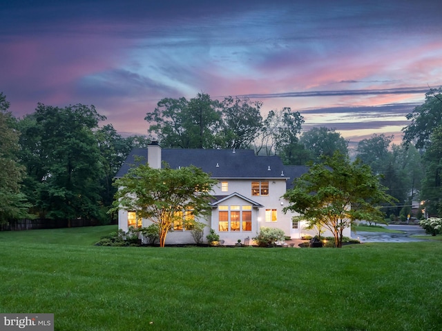 view of front of house featuring a chimney and stucco siding