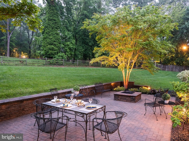 view of patio / terrace with a fire pit and outdoor dining area