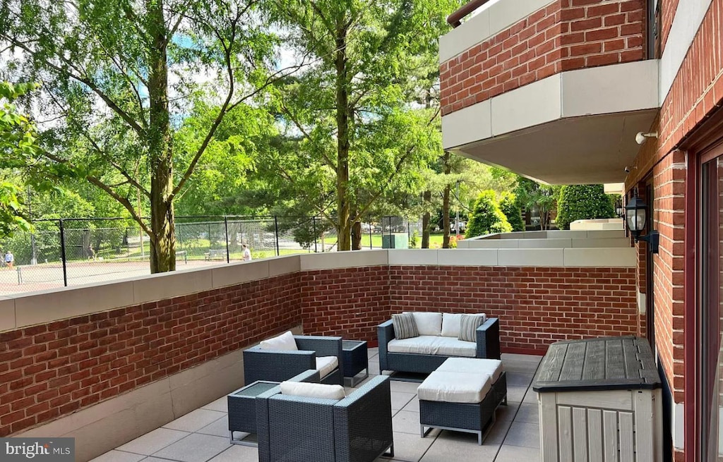 2301 N St NW Unit 101, Washington, DC 20037 - view of patio featuring an outdoor hangout area, fence, and view of scattered trees
