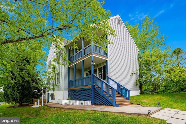 4346 Ballenger Creek Pike, Frederick, MD 21703 - view of front facade featuring a balcony, a front lawn, covered porch, and stairway