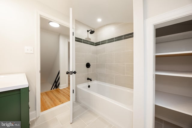 full bath with tile patterned flooring, shower / bathtub combination, vanity, and recessed lighting