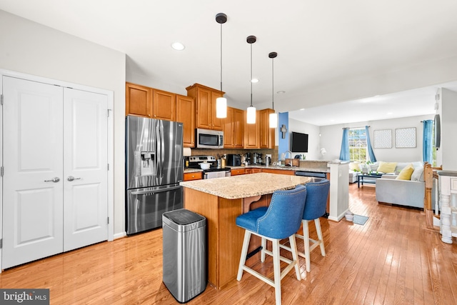 128 Michele Way Unit 38, Cinnaminson, NJ 08077 - kitchen featuring appliances with stainless steel finishes, open floor plan, light wood-style flooring, a peninsula, and recessed lighting