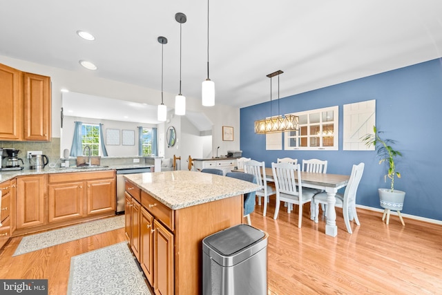 128 Michele Way Unit 38, Cinnaminson, NJ 08077 - kitchen featuring stainless steel dishwasher, a sink, light wood-type flooring, light stone countertops, and a kitchen island