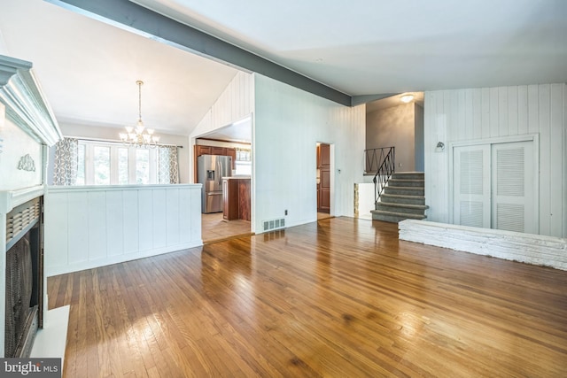 147 Heather Rd, Haddon Township, NJ 08107 - unfurnished living room with stairs, a fireplace, a chandelier, and hardwood / wood-style flooring