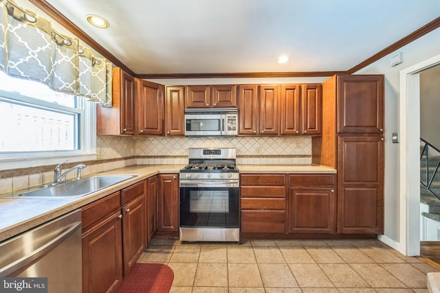 147 Heather Rd, Haddon Township, NJ 08107 - kitchen featuring appliances with stainless steel finishes, a sink, backsplash, light countertops, and ornamental molding