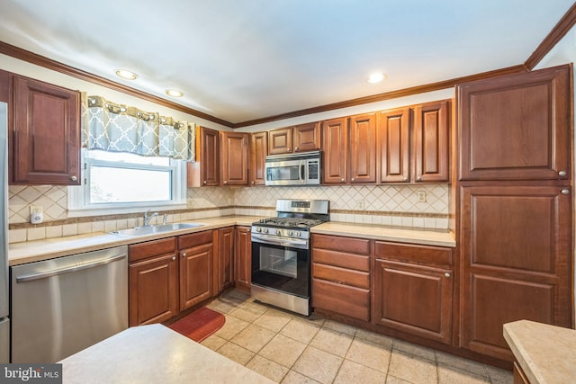 147 Heather Rd, Haddon Township, NJ 08107 - kitchen featuring appliances with stainless steel finishes, light countertops, a sink, backsplash, and ornamental molding