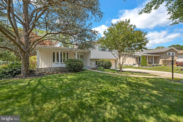 147 Heather Rd, Haddon Township, NJ 08107 - tri-level home with a front lawn, driveway, and stone siding