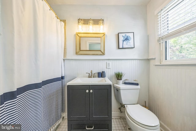 147 Heather Rd, Haddon Township, NJ 08107 - full bathroom featuring toilet, vanity, a wainscoted wall, tile patterned floors, and a shower with shower curtain