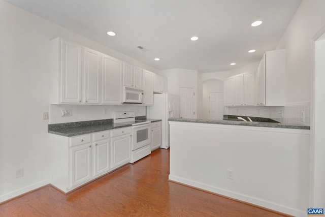 1269 Townbrook Xing, Charlottesville, VA 22901 - kitchen with white appliances, arched walkways, white cabinetry, and recessed lighting
