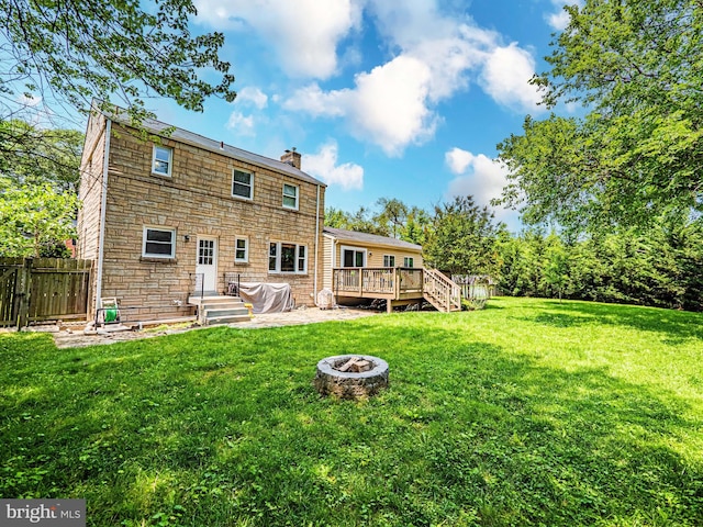 10021 Lorain Ave, Silver Spring, MD 20901 - rear view of property with a chimney, an outdoor fire pit, and a deck